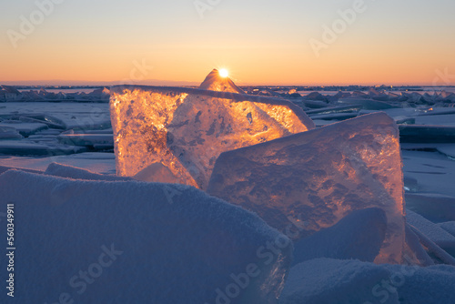 Winter sunrise at Lake Baikal, Russia. Blue ice at sunlight.