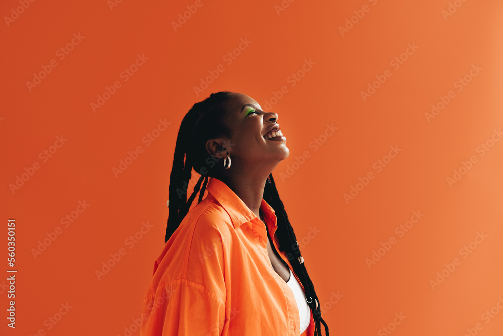 Woman with makeup smiling in a studio - obrazy, fototapety, plakaty 