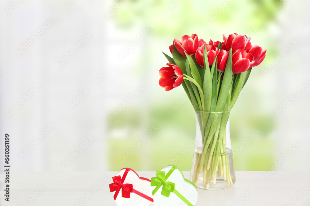 Happy Valentines Day greeting card. Decorative bouquet of tulips over blurred natural background. Concept of holidays, postcard, Mothers Day, Banner and 8 March. Space.