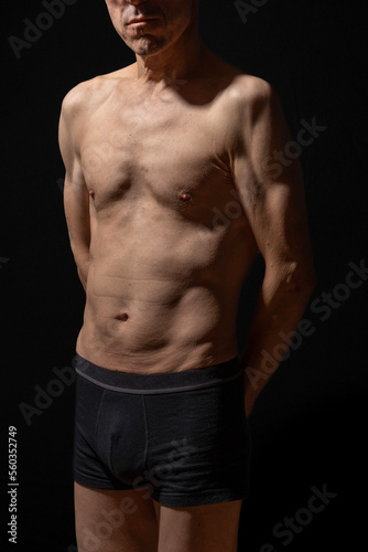 Paris, France - 01 09 2023: still life. Studio shot of a mature man posing shirtless