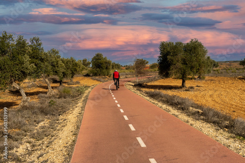 man riding a bike in arganda del rey bike lane photo