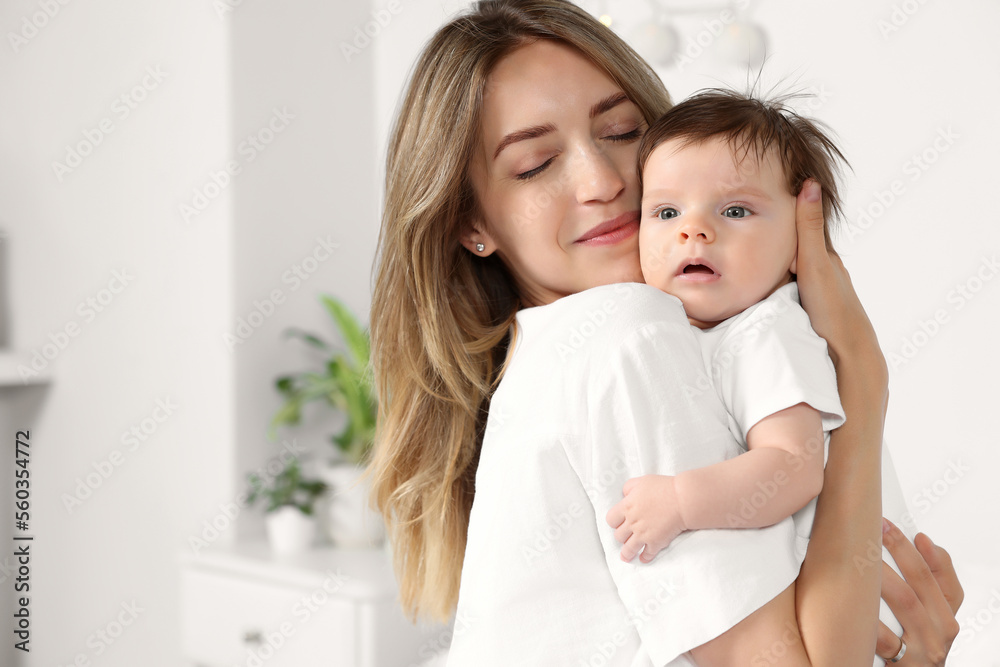 Mother hugging her cute little baby in room Mother hugging her cute little baby in room