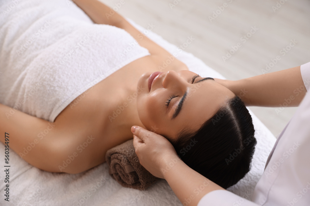 Young woman enjoying professional massage in spa salon Young woman enjoying professional massage in spa salon