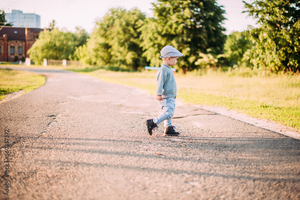 Cute and handsome baby boy 1-2 years old exploring nature in summer, having fun