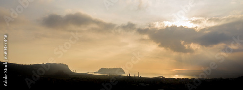 Sunset view of Nisida island in Naples, Italy. In the foreground the city in silhouette. photo