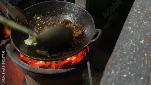 Someone is cooking javanese goat curry also known as Tongseng Kambing. This dish uses Gulai soup with sweet soy sauce and some cabbage. Tongseng and Sate Klathak usually found in Imogiri, Yogyakarta. photo