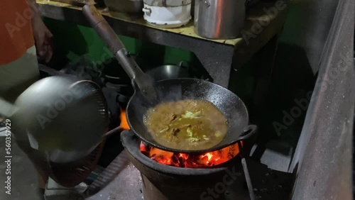 Someone is cooking javanese goat curry also known as Tongseng Kambing. This dish uses Gulai soup with sweet soy sauce and some cabbage. Tongseng and Sate Klathak usually found in Imogiri, Yogyakarta. photo