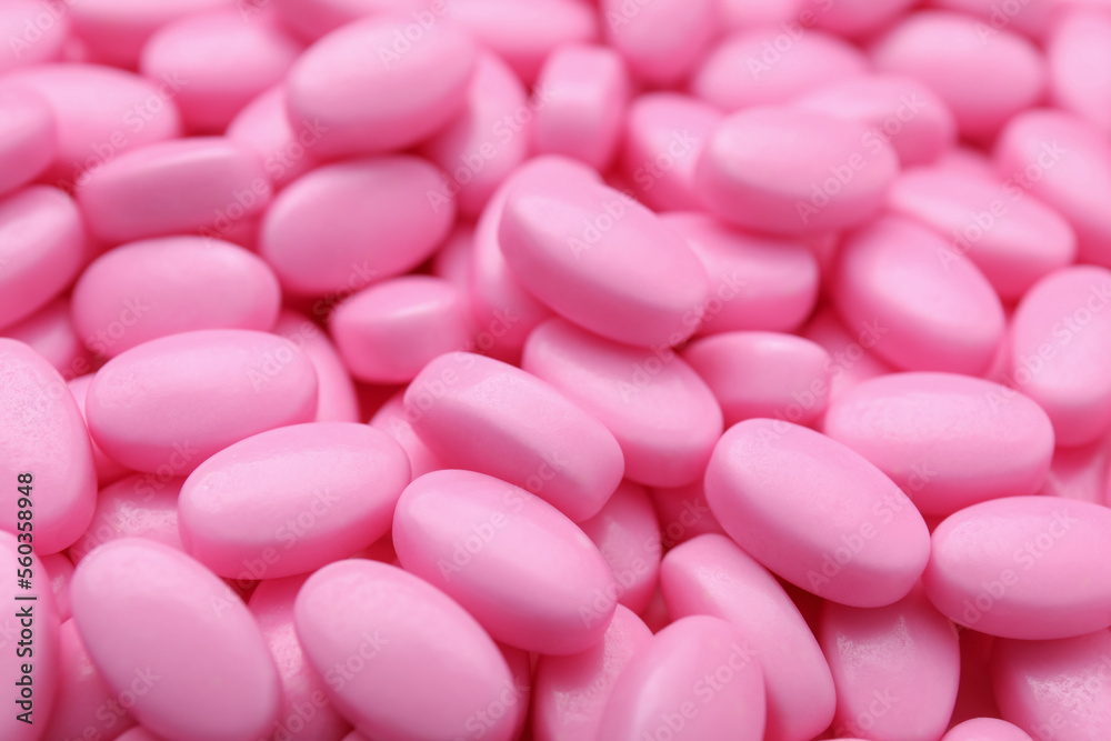 Many pink dragee candies as background, closeup