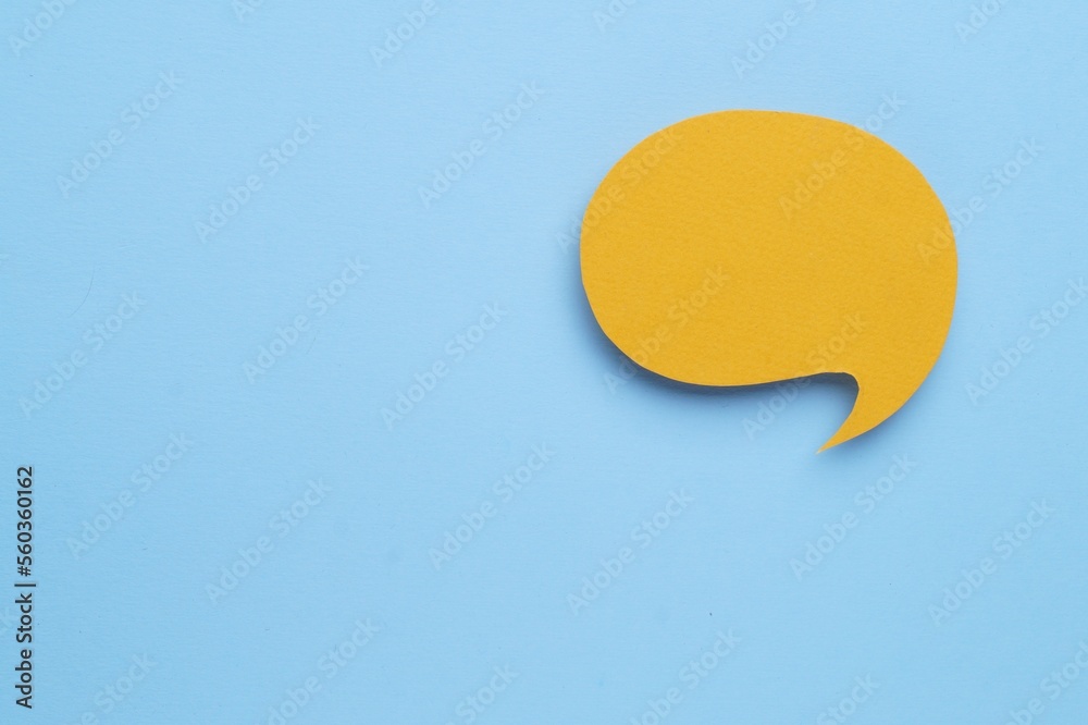 Paper speech bubble on light blue background, top view. Space for text Paper speech bubble on light blue background, top view. Space for text