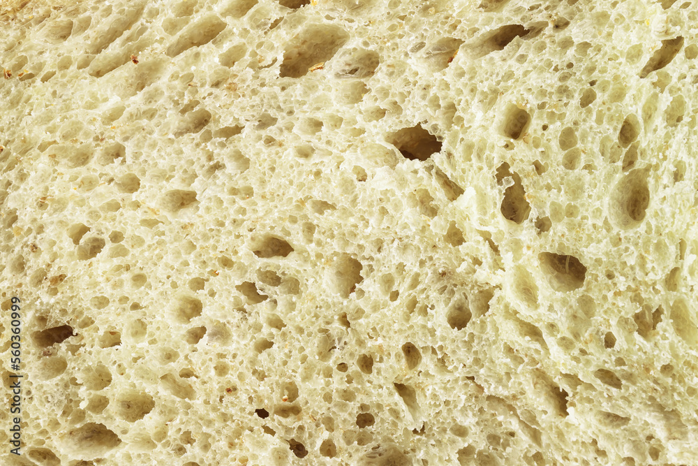 Pattern of pulp of whole grain bread. Texture of wheat bread. Food background. Healthy eating concept. Macro photo.