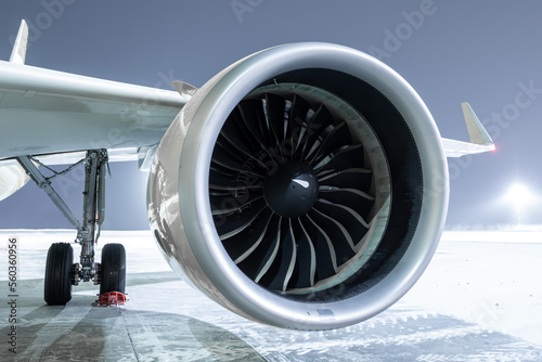 Close-up of engine of big passenger airliner at winter night
