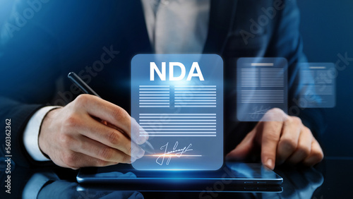 Non disclosure agreement concept. Businessman signs NDA document