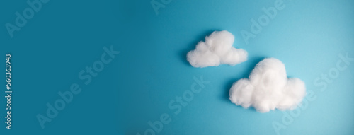 Pattern of white fluffy clouds made of cotton wool on a blue background