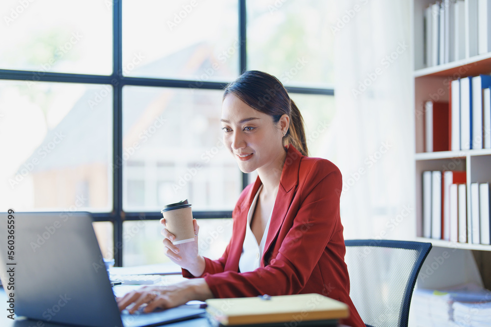 business woman sitting and drinking coffee and smiling happily business woman sitting and drinking coffee and smiling happily