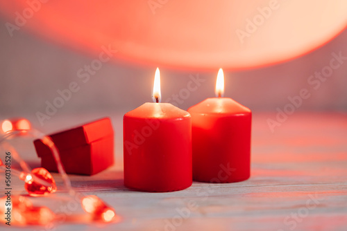 Beautiful composition with red candles on the white wooden table. Romantic love image