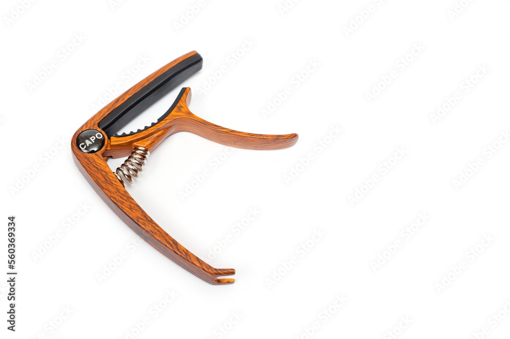 Metal capo for guitar with spring painted wood. Metal capo for guitar with spring painted wood.