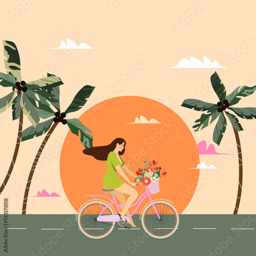 A young woman rides a bicycle against the backdrop of a sunset cityscape with palm trees in the sea bay. Girl outdoors, cardio exercises, healthy lifestyle