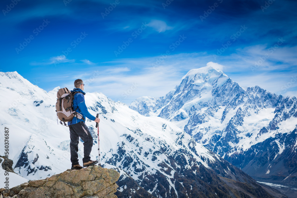 Hiker with backpack on the mountain top. Sport and active life concept