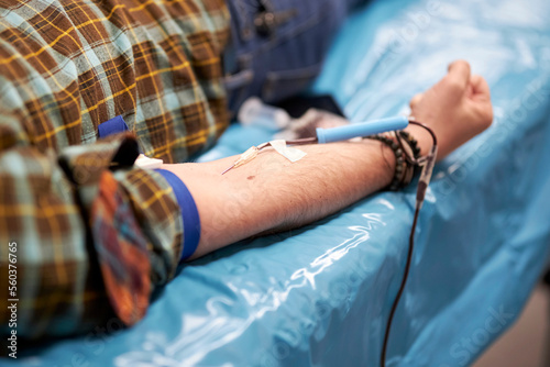 a nurse takes a blood sample.Close up Hand of a nurse or doctor in gloves taking a blood sample from a patient in a hospital. Close up Of Doctor Injecting Patient With Syringe To Collect Blood Sample