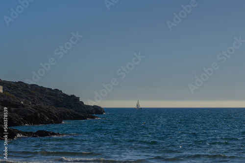 Beautiful blue sea with little boat and rocks