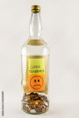 Obraz na plátne Large old glass gallon bottle savings jar with loose change coins and notes cash