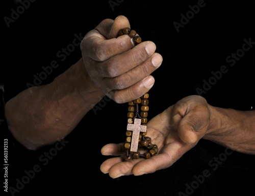 man praying to god with hands together Caribbean man praying on white background with people stock photo