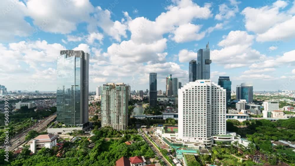 Jakarta, Indonesia: Time lapse of clouds moving fast above the Jakarta business modern skyline with skyscrapers and condominium towers in Indonesia capital city. Jakarta, Indonesia: Time lapse of clouds moving fast above the Jakarta business modern skyline with skyscrapers and condominium towers in Indonesia capital city.