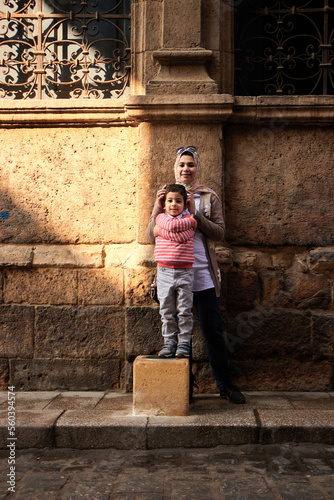 Cairo, Egypt- June 26 2020: Moez Street with few local visitors and Sabil-Kuttab of Katkhuda Mamluk era historic building at the far end during Covid-19 lockdown period, Gamalia district, Old Cairo photo