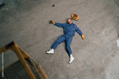 Top view of dead factory worker that lying on the ground