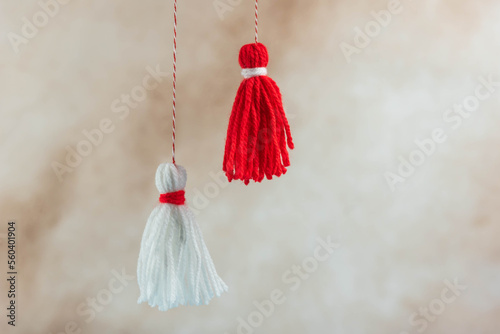 Traditional Martisor - symbol of holiday 1 March, Martenitsa, Baba Marta, beginning of spring and seasons changing in Romania, Bulgaria, Moldova. Greeting and post card for holidays. photo