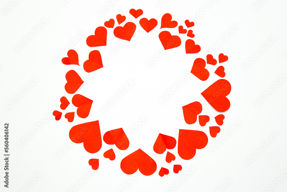 Valentine’s day background. Red hearts in a circle shape isolated on white. Love-shaped paper-cut decorations for International Women’s Day or Mother’s Day. Flat lay. Copy space Valentine’s day background. Red hearts in a circle shape isolated on white. Love-shaped paper-cut decorations for International Women’s Day or Mother’s Day. Flat lay. Copy space