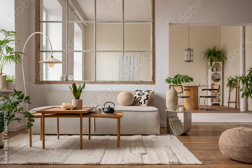 Creative composition of living room interior with modular sofa  beige rug  plants  vase with green leaves  pouf  stylish coffee table  big window  lamp and personal accessories. Home decor. Template.