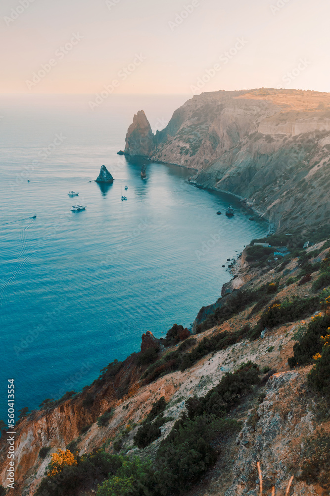 Beautiful view of mediterranean sea cliff coast. Blue water lagoon in evening sunset light. Travel destination, nature and eco tourism 
