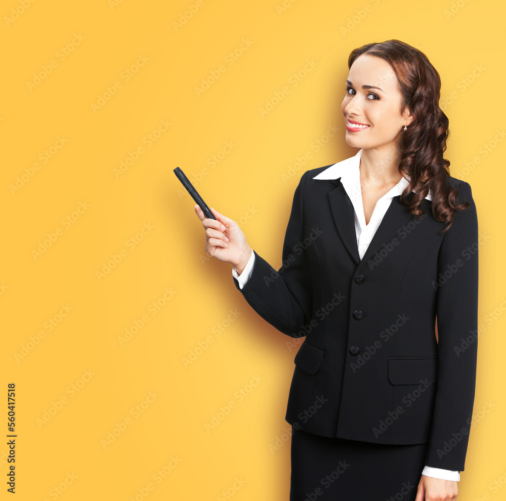 Portrait image of smiling beautiful business woman in confident suit, showing pointing advertising, isolated yellow background. Businesswoman, executive office worker, teacher gesturing Portrait image of smiling beautiful business woman in confident suit, showing pointing advertising, isolated yellow background. Businesswoman, executive office worker, teacher gesturing