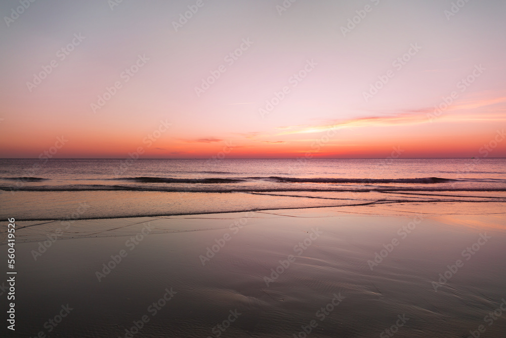 Calm sea with sunset sky with cloud.