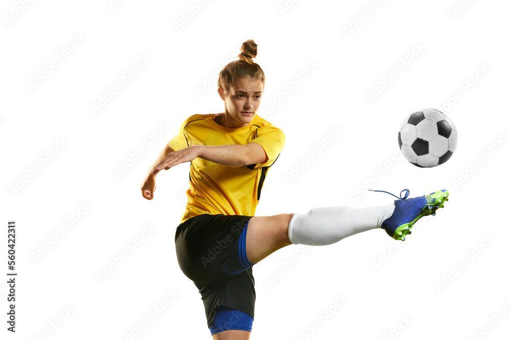 Hitting ball with leg. Young professional female football player in motion, training, playing football, soccer isolated over white background