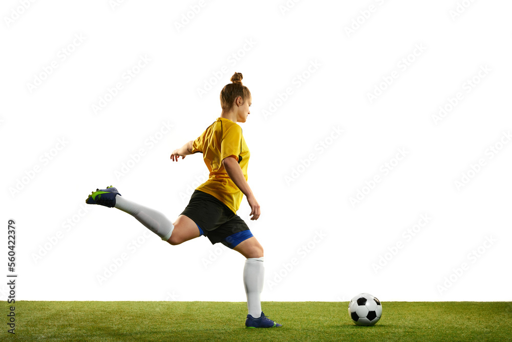 Winning goal. Young professional female football player in motion, training, playing football, soccer isolated over white background