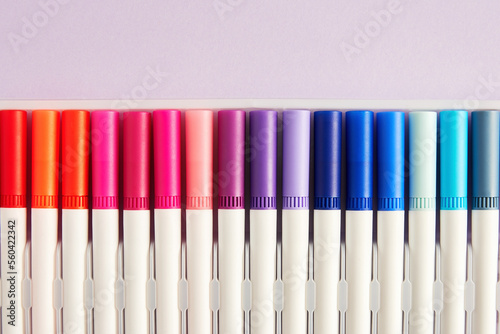 Set of watercolor markers for drawing and sketching on purple background. Hobby and leisure activity. Copy space for text
