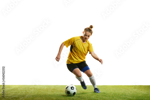 Dribbling. Concentrated young professional female football player in motion, playing football, soccer isolated over white background