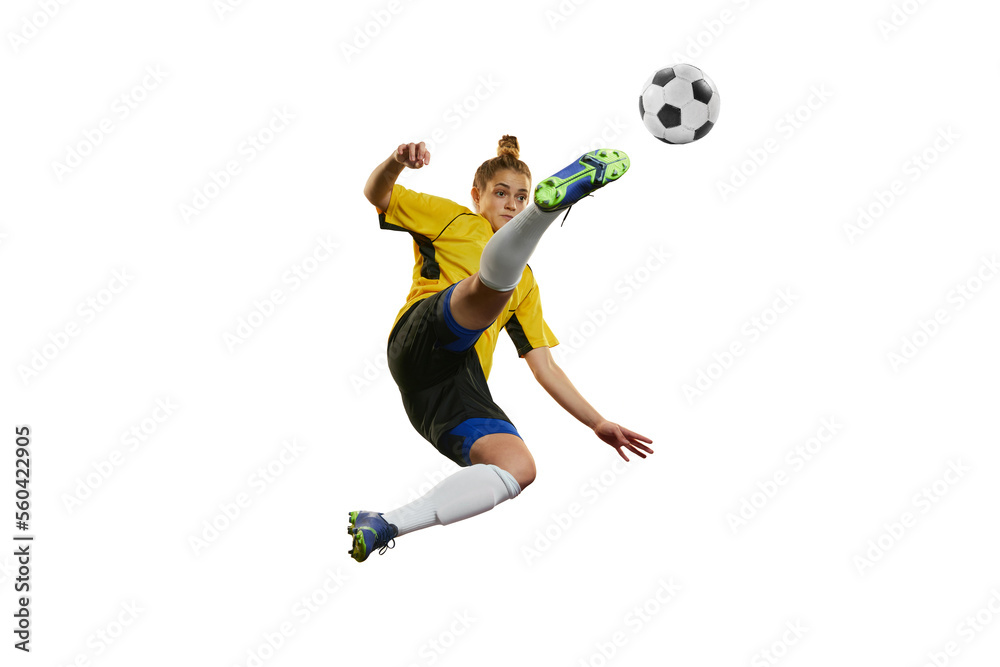 Hitting ball in a jump. Young professional female football, soccer player in motion, training, playing isolated over white background