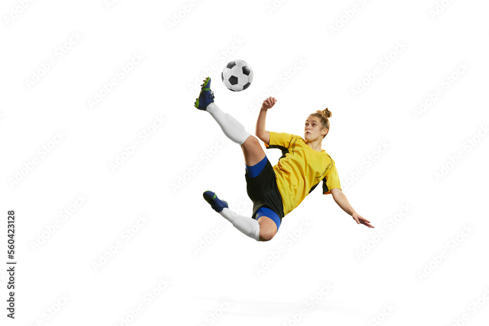 Leg kick. Young professional female football, soccer player in motion, training, playing isolated over white background