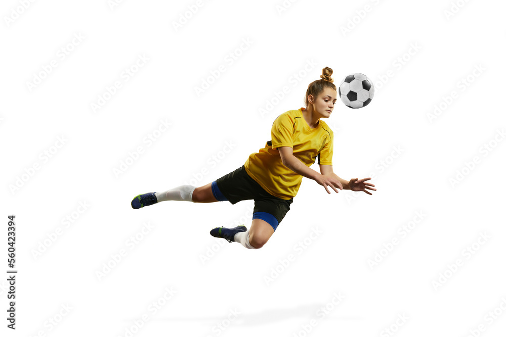 Hitting ball with head. Young woman, professional female football, soccer player in motion, training, playing isolated over white background