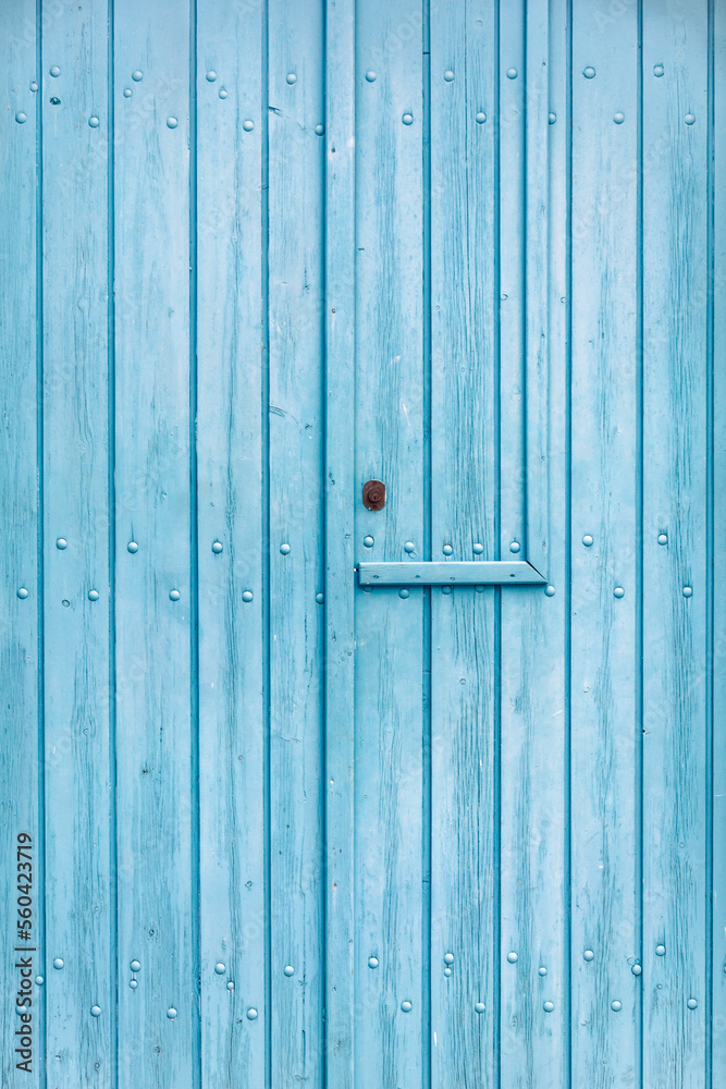 Texture of an old wooden door painted blue somewhere in Greece Texture of an old wooden door painted blue somewhere in Greece