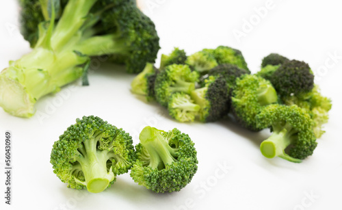 fresh broccoli and florets on white background