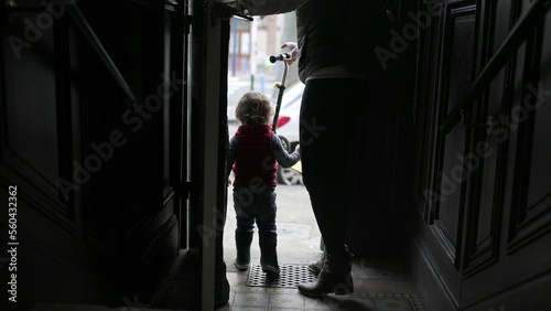 Wallpaper Mural Mother and baby child stepping outside. Parent and toddler going out opening front door Torontodigital.ca