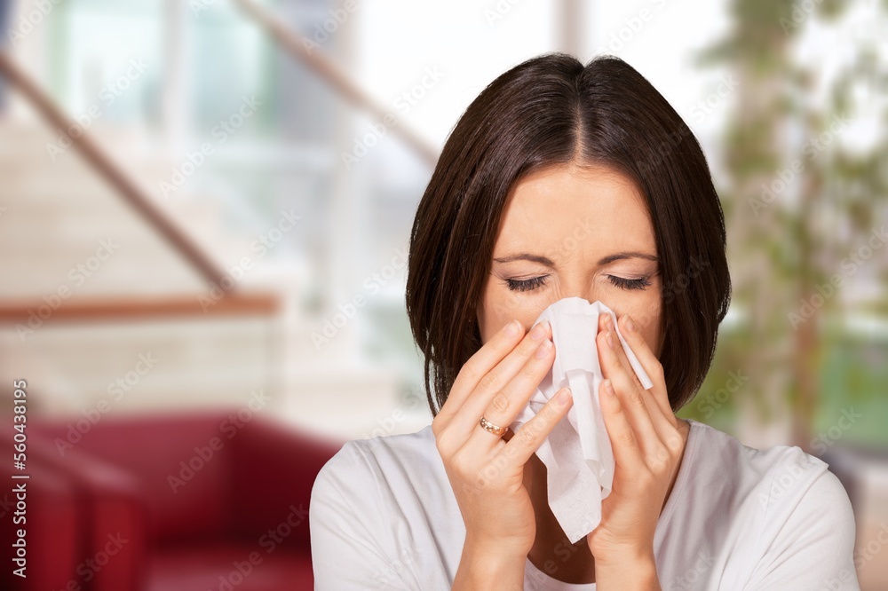 Sick young woman with fever, use tissues Sick young woman with fever, use tissues