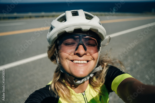 Happy active female cyclist make selfie © IBRESTER
