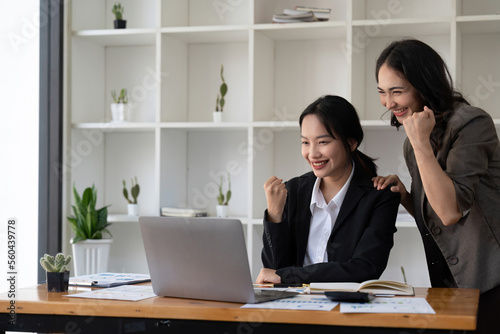 Group of Young Asian business team creative businesspeople coworker in office Happy to be successful partnership teamwork celebrating achievement and success concept