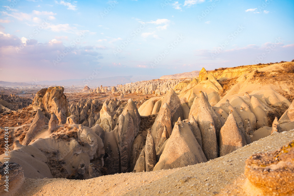 Stunning view of some rock formations in the Red & Rose Valley in Cappadocia during a beautiful sunrise. Goreme, central Anatolia, Turkey