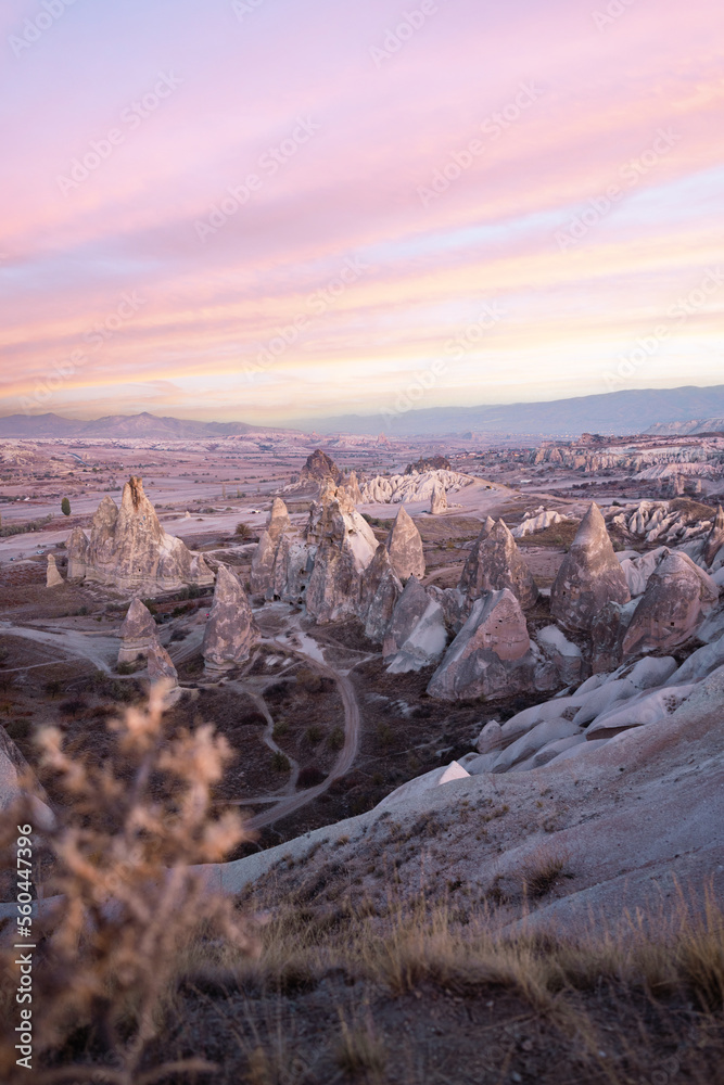 Stunning view of some rock formations in the Red & Rose Valley in Cappadocia during a beautiful sunrise. Goreme, central Anatolia, Turkey